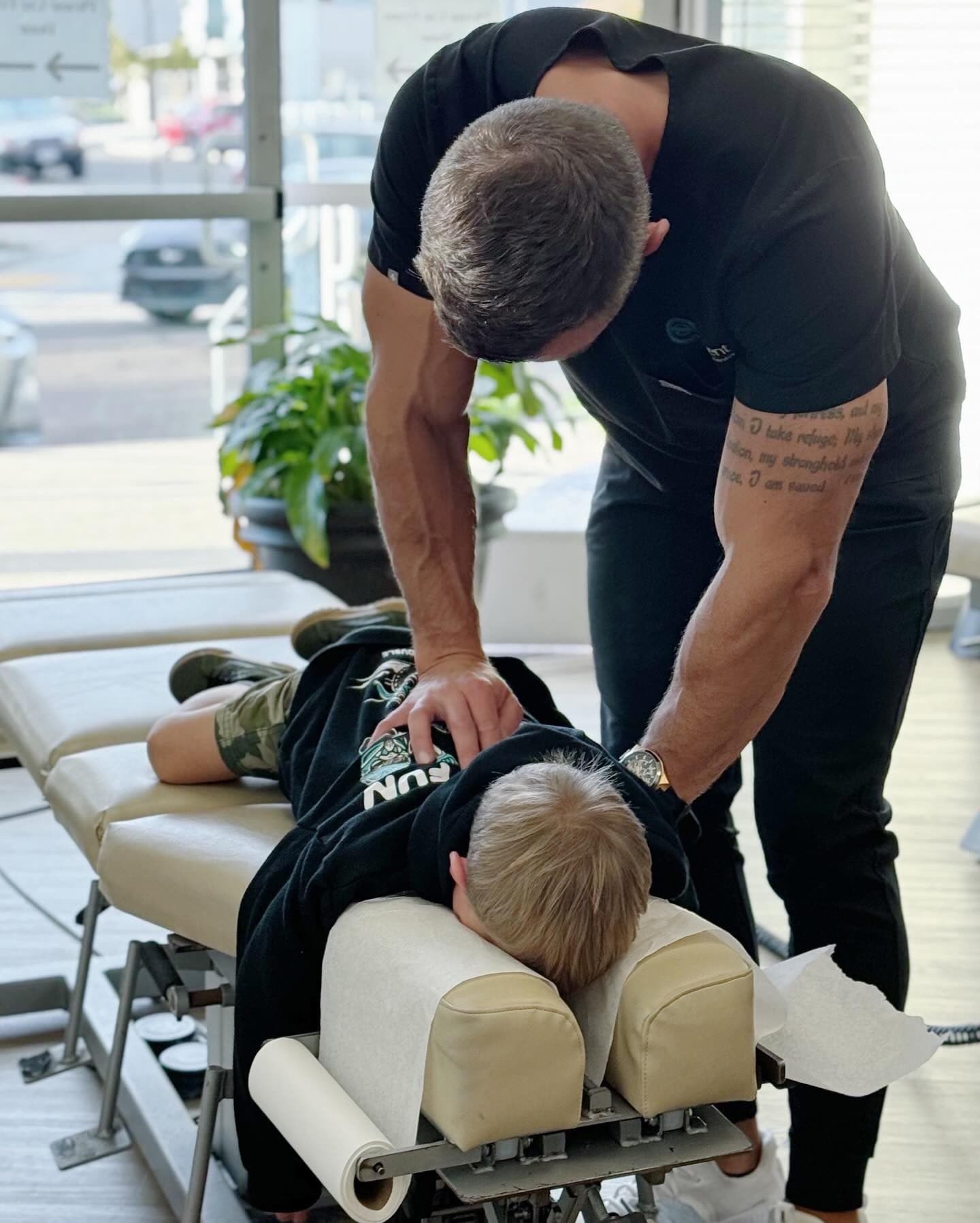 An Element Wellness Center chiropractor performing a gentle adjustment on a young patient