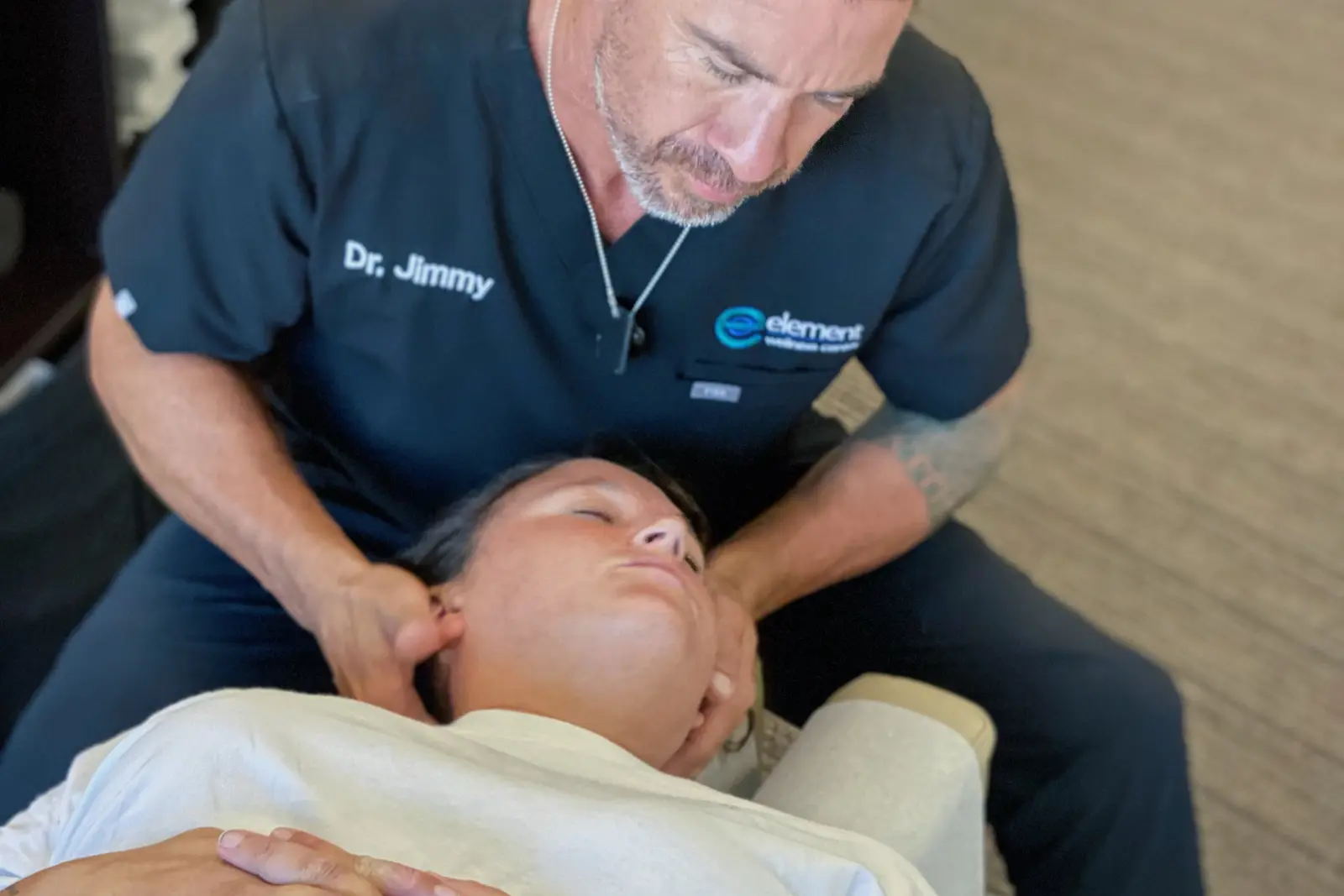 Dr. Jimmy Lopez performing a chiropractic cervical adjustment on a patient at Element Wellness Center in San Diego